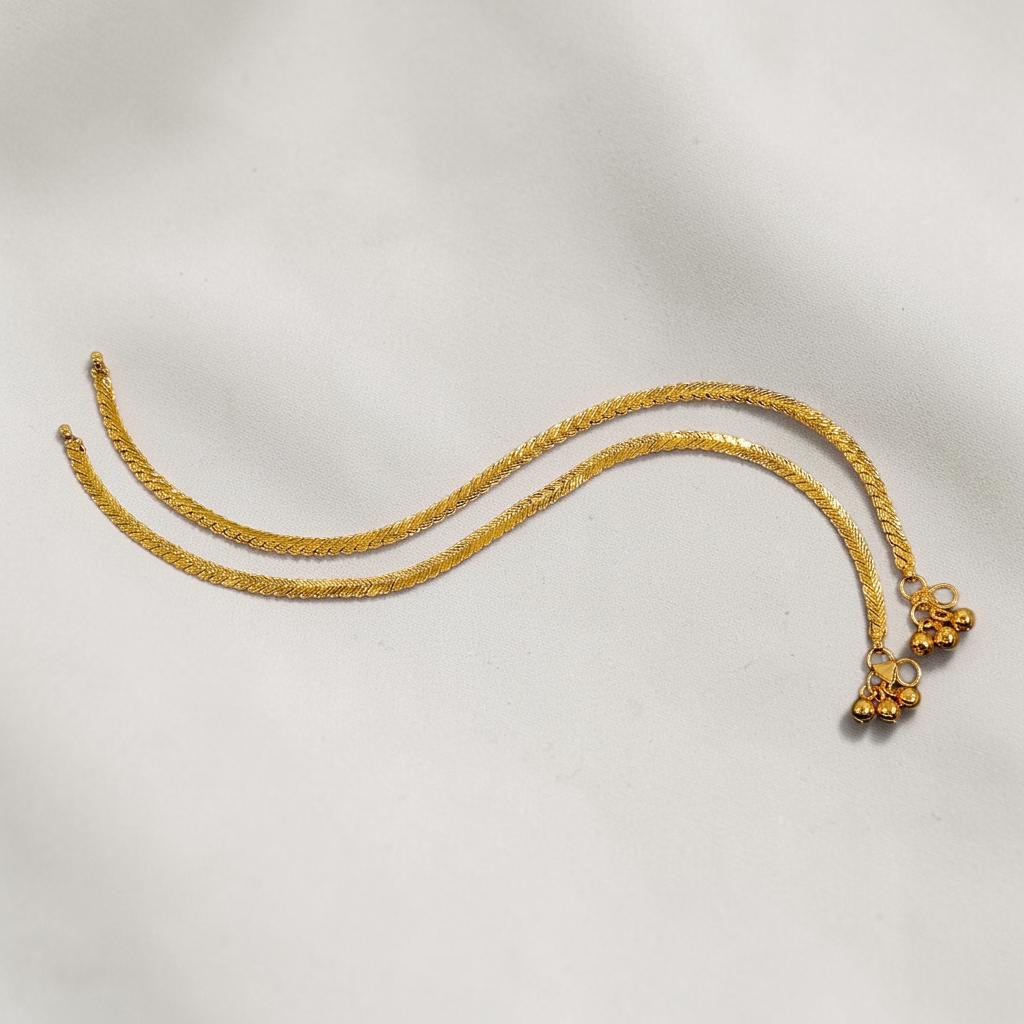 Lakx Fashion gold-toned brass anklets with a braided herringbone chevron chain and delicate hanging ghungroo bells.