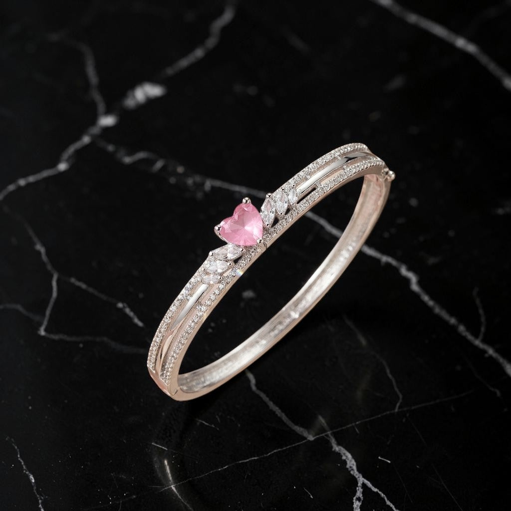 Lakx Fashion rhodium-tone hinged kada featuring a heart-shaped pink stone and clear marquise-cut CZ accents.