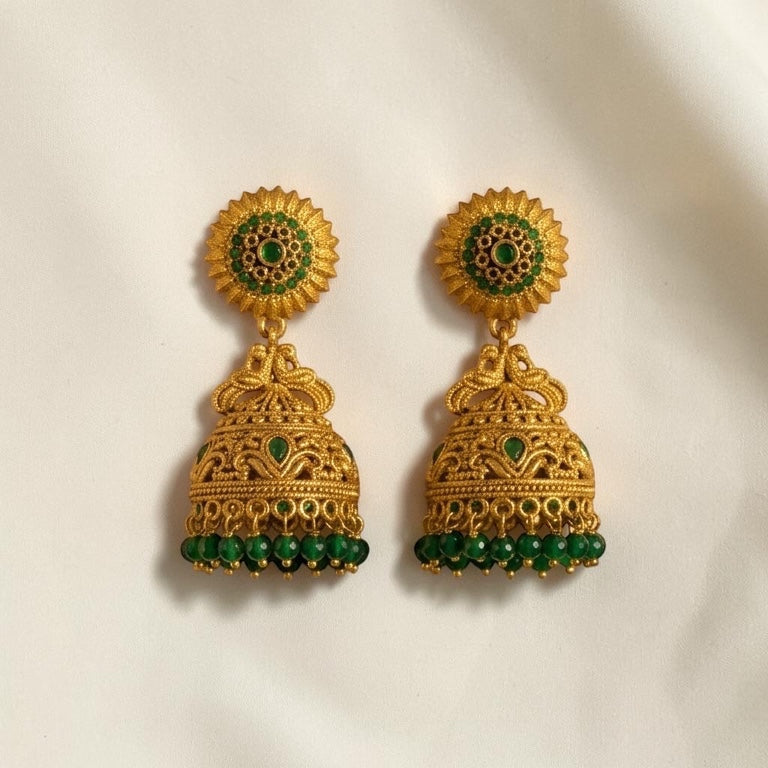 Lakx Fashion antique gold-tone brass jhumka earrings with green stone embellishments and beaded dome drops.