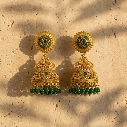 Lakx Fashion antique gold-tone brass jhumka earrings with green stone embellishments and beaded dome drops.