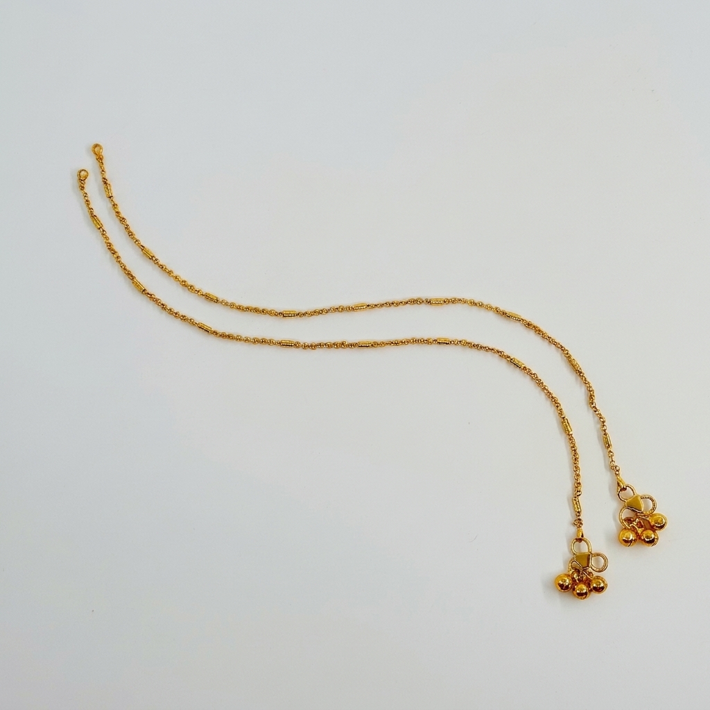 Lakx Fashion gold-toned brass anklets featuring delicate link chains, cylinder beads, and small ghungroo bells.