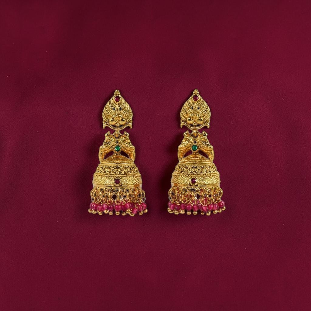 Lakx Fashion gold-tone brass Lakshmi jhumka earrings with green and ruby stones and pink beaded fringe.
