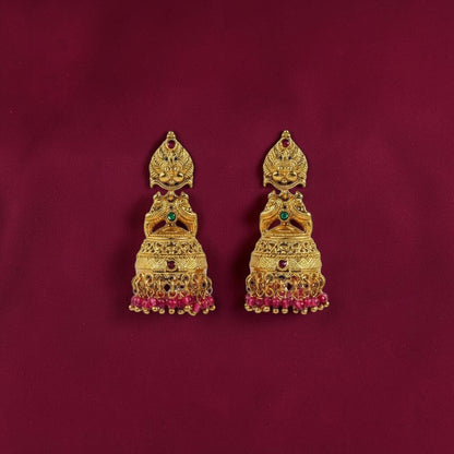 Lakx Fashion gold-tone brass Lakshmi jhumka earrings with green and ruby stones and pink beaded fringe.
