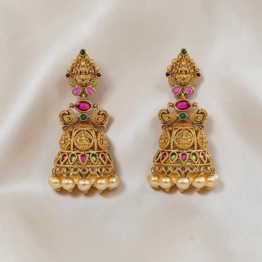 Lakx Fashion gold-tone brass jhumka earrings with temple design, colorful stones, and dangling yellow pearls.