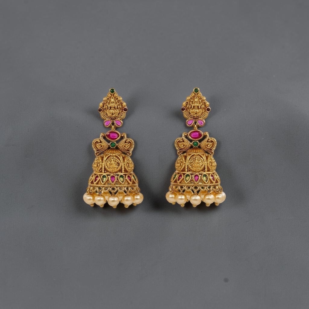 Lakx Fashion gold-tone brass jhumka earrings with temple design, colorful stones, and dangling yellow pearls.