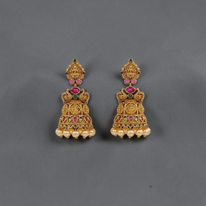 Lakx Fashion gold-tone brass jhumka earrings with temple design, colorful stones, and dangling yellow pearls.