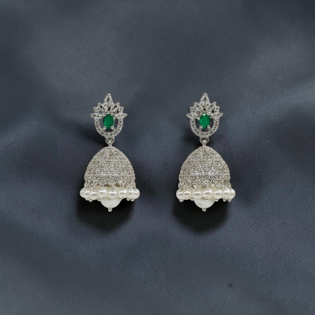 Lakx Fashion rhodium-tone jhumka earrings with green oval stones, white CZ accents, and dangling white pearls.