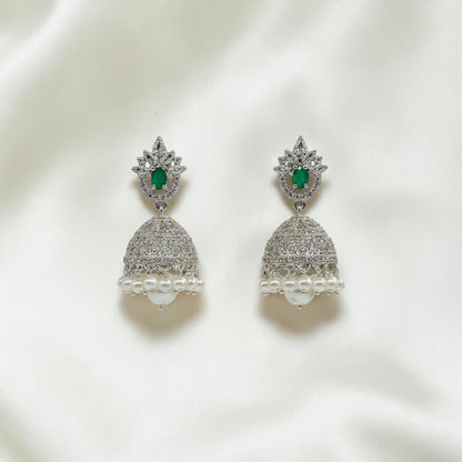 Lakx Fashion rhodium-tone brass jhumka earrings with green oval stones, white CZ accents, and dangling white pearls.
