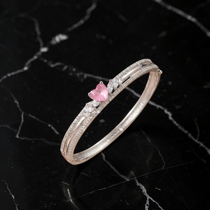 Lakx Fashion rhodium-tone hinged kada featuring a heart-shaped pink stone and clear marquise-cut CZ accents.
