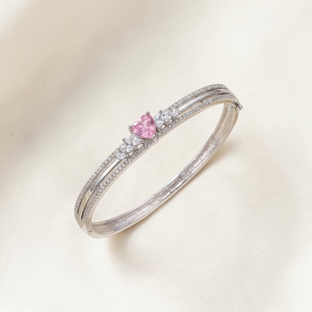 Lakx Fashion rhodium-tone hinged kada with a central heart-shaped pink stone and clear marquise-cut accents.