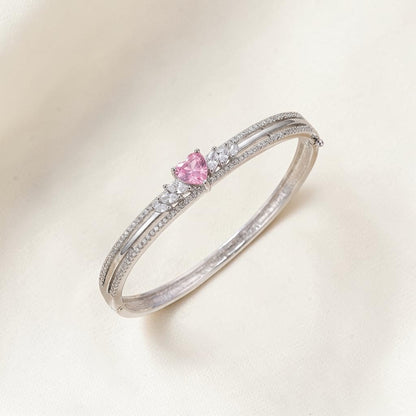 Lakx Fashion rhodium-tone hinged kada with a central heart-shaped pink stone and clear marquise-cut accents.