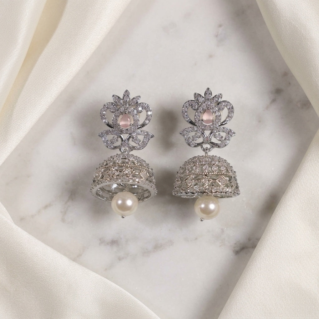 Lakx Fashion rhodium-tone jhumka earrings with pink oval stones, white CZ accents, and dangling pearl drops.