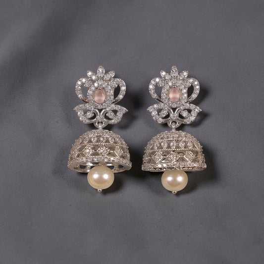 Lakx Fashion rhodium-tone brass jhumka earrings with pink oval stones, white CZ accents, and hanging pearl drops.