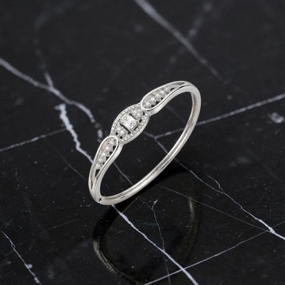 Lakx Fashion rhodium-tone brass hinged kada bracelet with a central emerald-cut stone and pavé-set clear CZ stones.