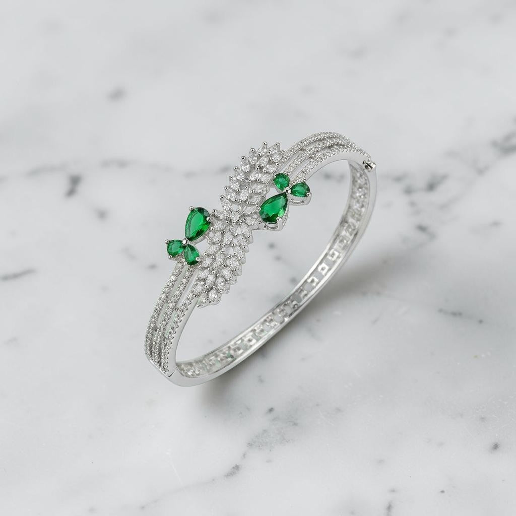 Lakx Fashion rhodium-tone brass bracelet with green marquise stones and white CZ leaf-inspired clusters.