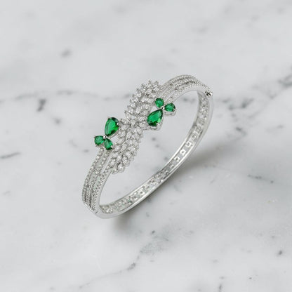 Lakx Fashion rhodium-tone brass bracelet with green marquise stones and white CZ leaf-inspired clusters.