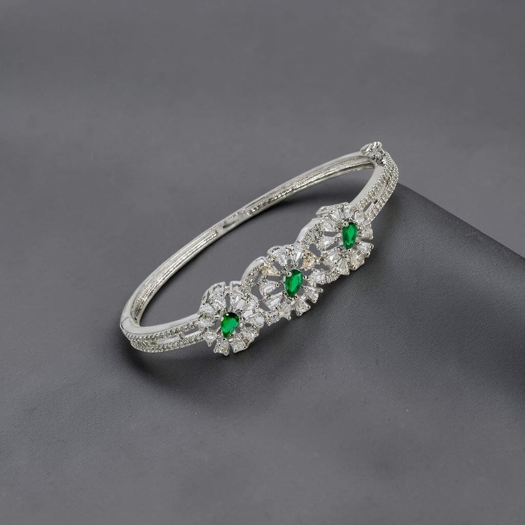 Lakx Fashion rhodium-tone brass bracelet with green marquise-cut stones and white CZ floral leaf accents.