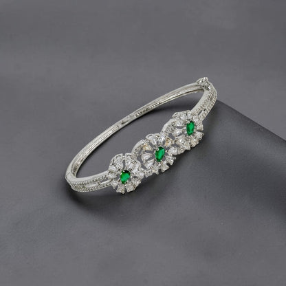 Lakx Fashion rhodium-tone brass bracelet with green marquise-cut stones and white CZ floral leaf accents.