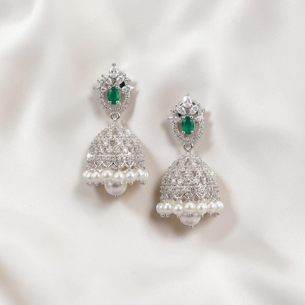 Lakx Fashion rhodium-tone jhumka earrings with green teardrop stones, white CZ accents, and hanging pearl drops.