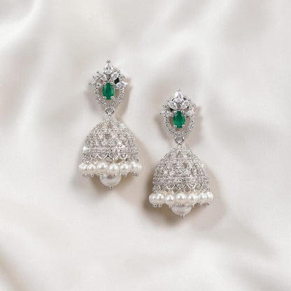 Lakx Fashion rhodium-tone jhumka earrings with green teardrop stones, white CZ accents, and hanging pearl drops.