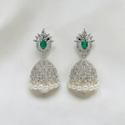 Lakx Fashion rhodium-tone jhumka earrings with green teardrop stones, white CZ accents, and hanging pearl drops.