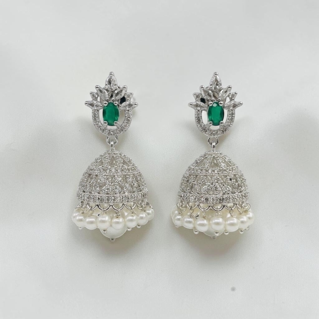 Lakx Fashion rhodium-tone jhumka earrings with green teardrop stones, white CZ accents, and hanging pearl drops.