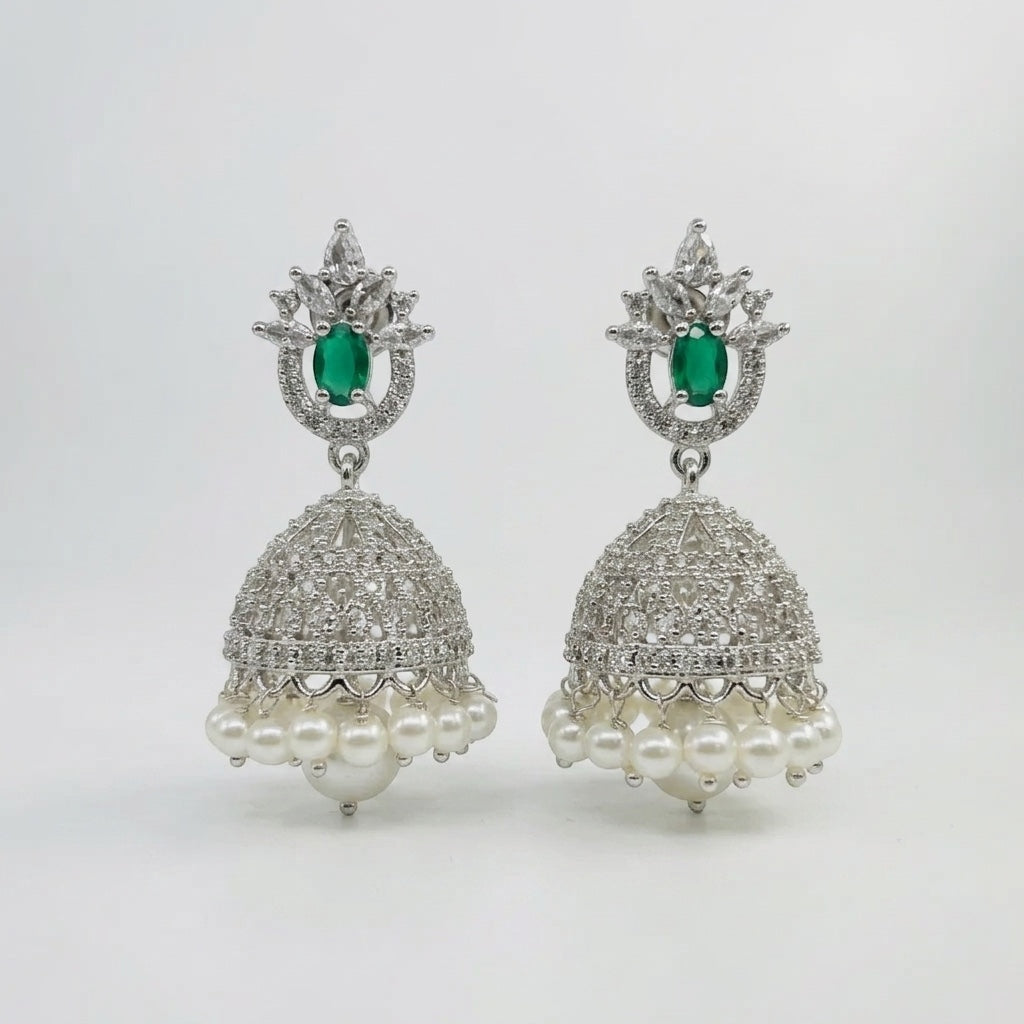 Lakx Fashion rhodium-tone jhumka earrings with green teardrop stones, white CZ, and pearl drops on a white background