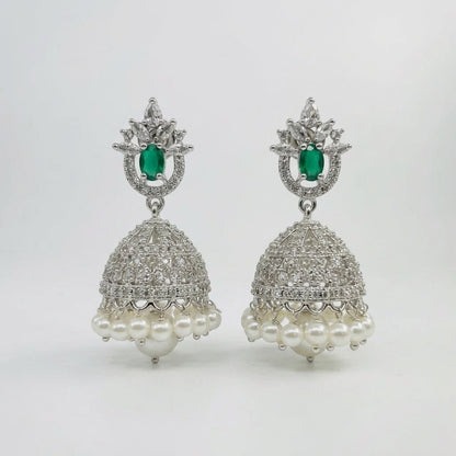 Lakx Fashion rhodium-tone jhumka earrings with green teardrop stones, white CZ, and pearl drops on a white background